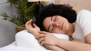 A woman is sleeping on the Elviros Ergonomic Pillow Design