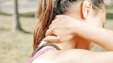 A woman is struggling with neck pain