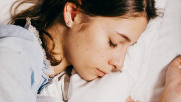 A woman is sleeping on Elviros pillow