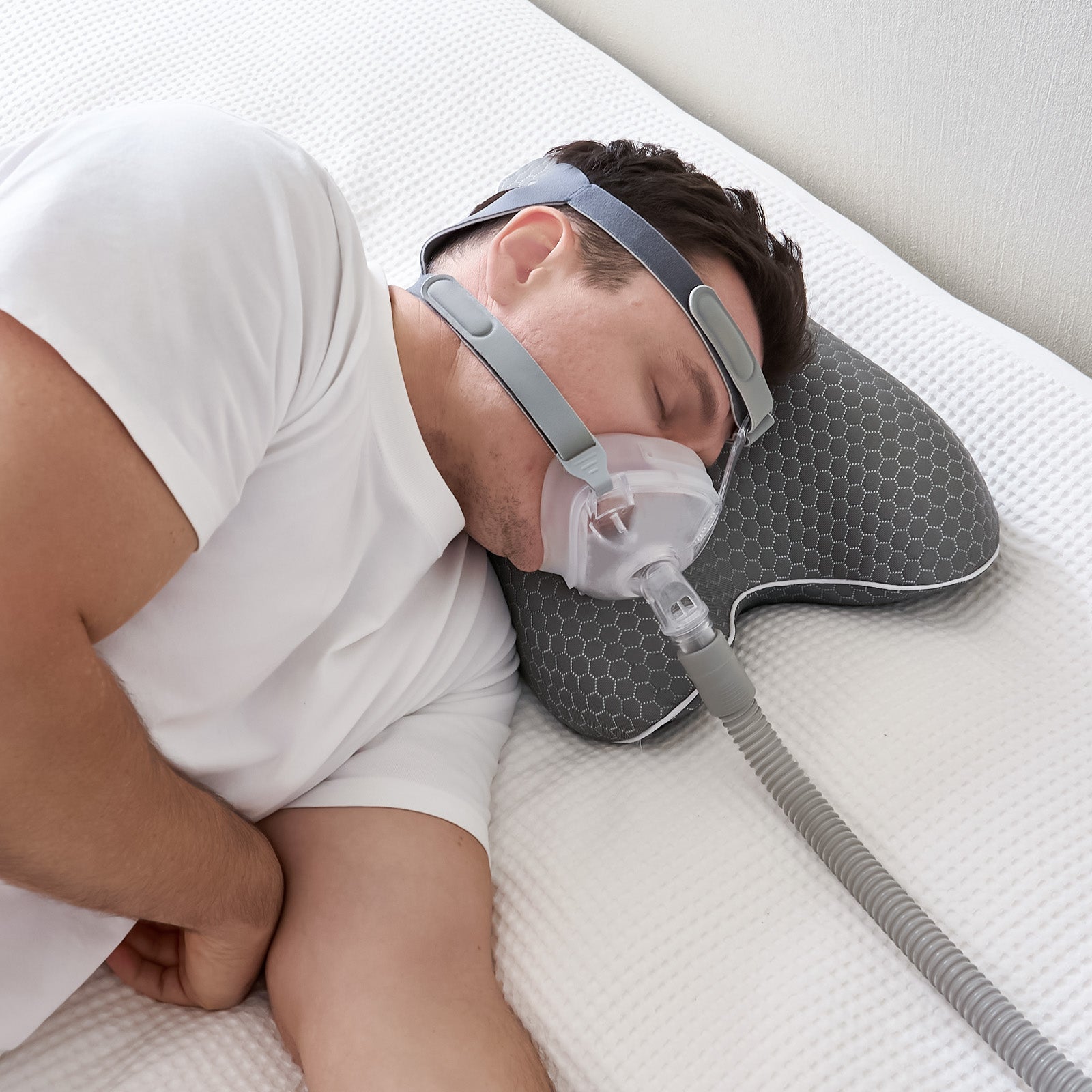 Traveller using a compact CPAP pillow