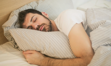 A side sleeper rests comfortably on a memory foam pillow